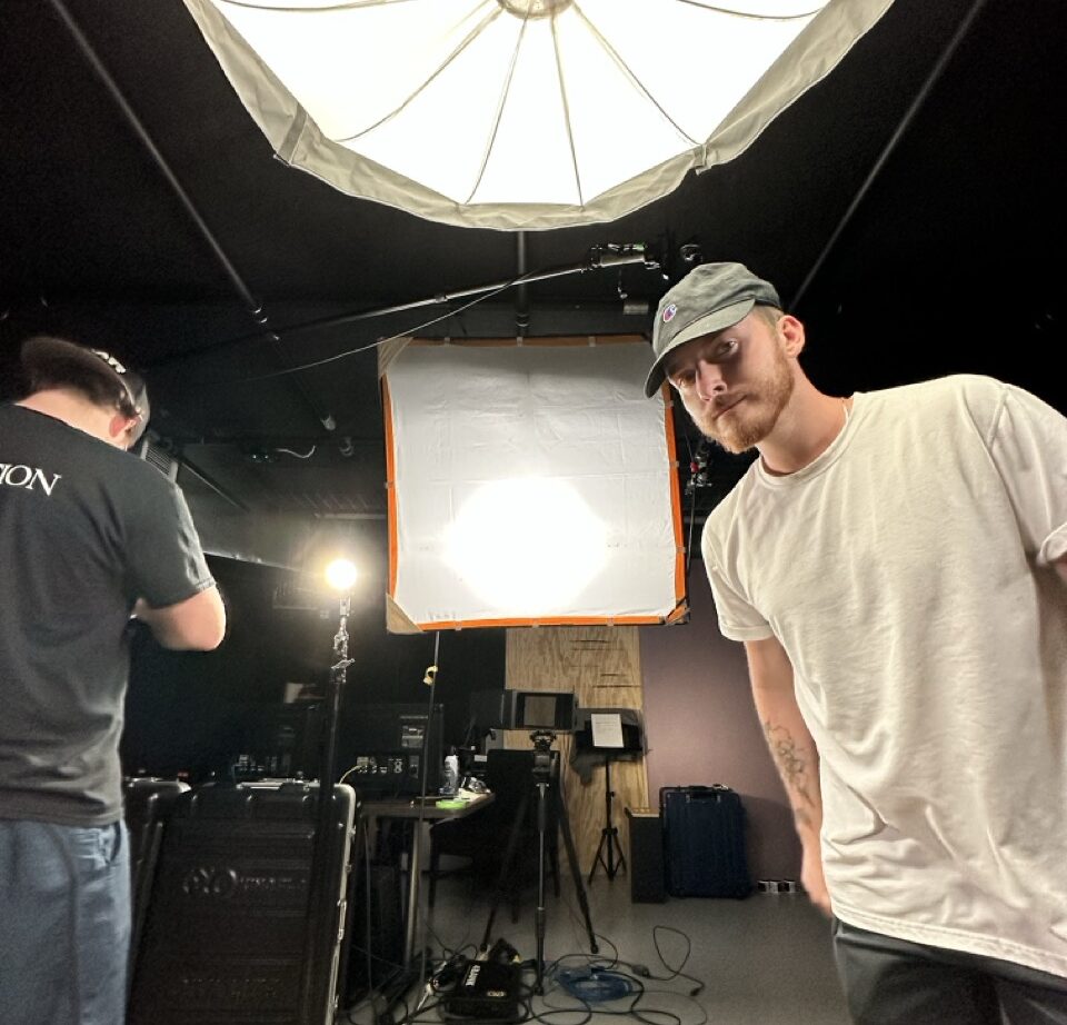 Filmmaker stares into camera on set