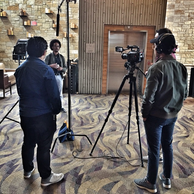 A small video crew conducts an on-camera interview.